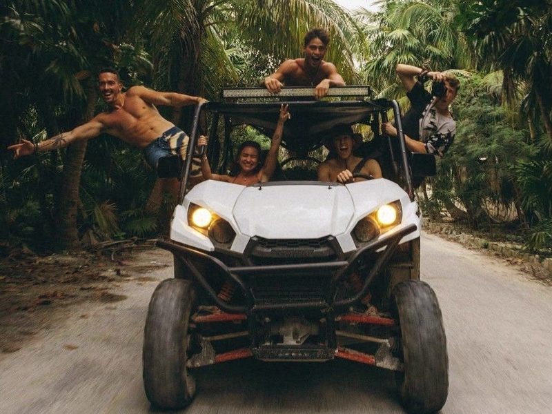 Friends on an off-road buggy on a jungle track