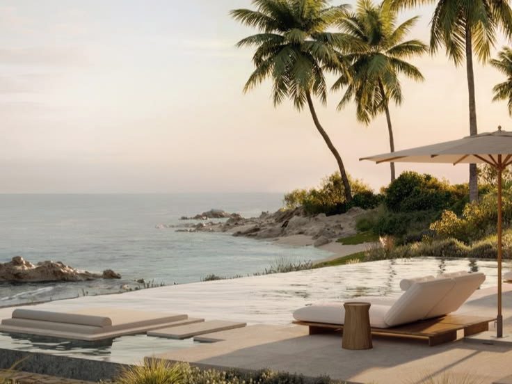 Villa terrace with an infinity pool, loungers and palms at sunset
